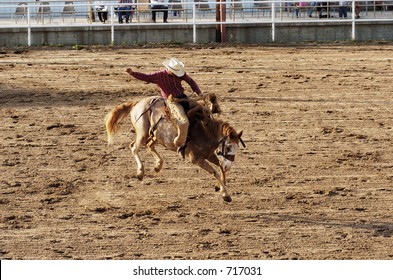 Saddle bronc riding rodeo competition.