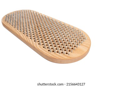 Sadhu board isolated on white background. The practice of standing on nails. Yoga concept.
