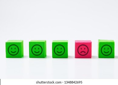 Sadness, Depression, Isolation And Loneliness Is Symbolized In This Picture Of One Sad Face Among Many Smiling Faces