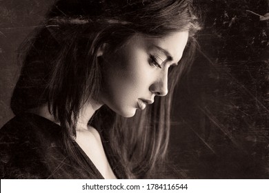 Sadness melancholy portrait, beautiful young girl. Side face close-up headshot of serious unhappy female teenage, dark vintage artistic effect