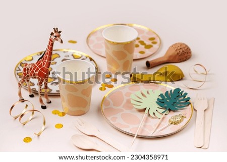 Safari animals birthday party decorations and props. Cute paper party plates and cups for themed kids party. Set of holiday disposable tableware for party or picnic. 