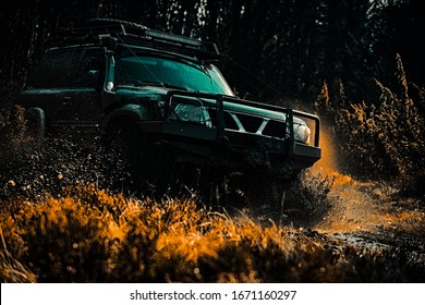 Safari suv. Mud and water splash in off the road racing. Off-road travel on mountain road. 4x4 travel trekking. Rally racing. Off road sport truck between mountains landscape