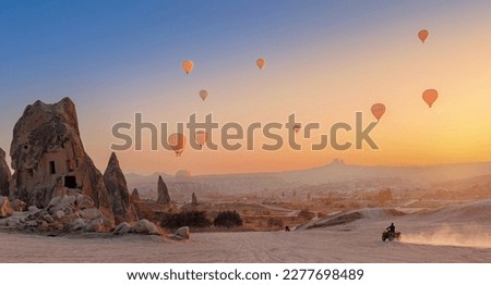 Safari trip ATV quad bike with set colorful hot air balloon in Cappadocia Goreme Turkey banner.