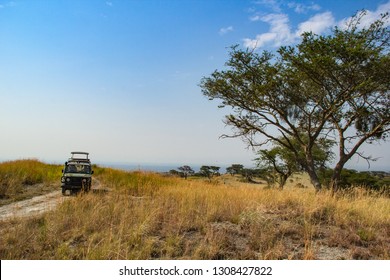 Safari Vehicle On Hill In Savannah In Queen Elizabeth National Park In Uganda Africa