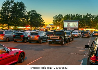 Safe entertainment and pastimes for families during coronavirus COVID-19 quarantine and isolation with two meters distance in summer 2020
Watching movies outdoors in the city parking lot on a warm sum