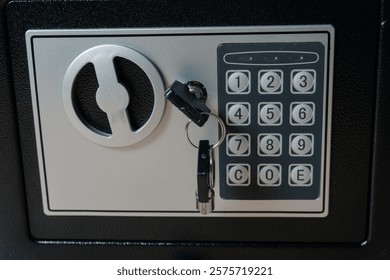 Safe or home security box with key and digital keypad.