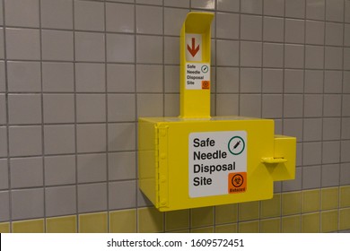 Safe Medical Needle Disposal Container On A Toilet Wall