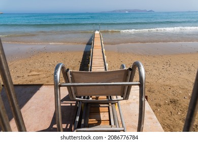 Safe Motorized Wheelchair Ramp, Used To Transport Disabled People Into The Sea Water For Swimming. Heraklion, Crete, Greece