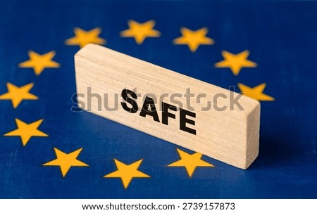SAFE Program. Security Action for Europe. Flag of the European Union and the word "Safe" on a wooden block. Concept of support for the European defense industry