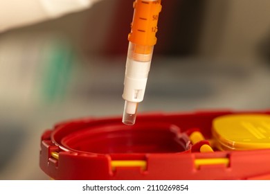 Safe Recape: A Nurse Throwing A Needle Into A Sharps Bin