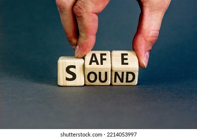 Safe and sound symbol. Businessman turns cubes and changes the word 'safe' to 'sound' or vice versa. Beautiful grey background, copy space. Business, safe and sound concept. - Shutterstock ID 2214053997