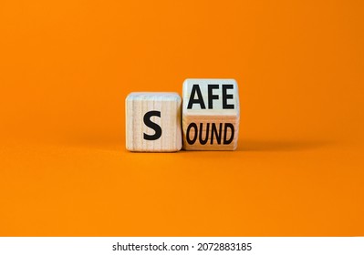 Safe and sound symbol. Turned a wooden cube and changed the word 'safe' to 'sound' or vice versa. Beautiful orange table, orange background, copy space. Business, safe and sound concept. - Shutterstock ID 2072883185