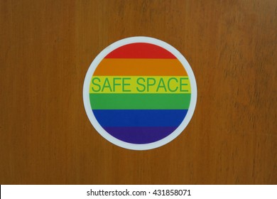 Safe Space Sign With Rainbow Colors On A Wooden Door