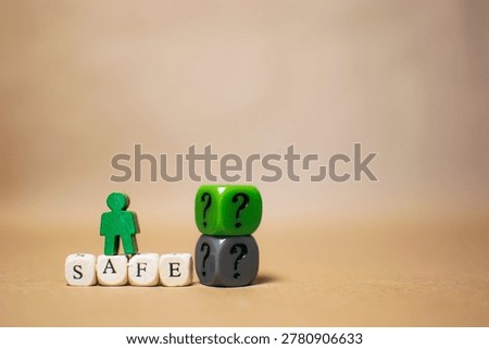 Safe word with question mark cubes and miniature person on beige background. Uncertainty, security and business decision concept.