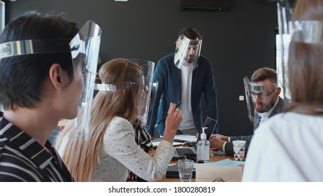 Safe Workplace After COVID-19 Lockdown. Happy Multiethnic Business People Team Wear Face Shields At Office Meeting.