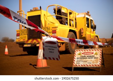 Safe workplace practice red and white warning danger tag tape sign applying taping off working area dropped object with crane lifting high risk work exclusion dropped zone construction site background - Shutterstock ID 1902675250