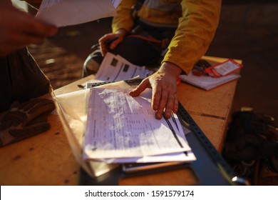 Safe Workplaces Construction Workers Are Double Checking Safety Paperwork JHA Of Hot Work Permit Prior Ensure Sign Off To Work Each Shift Early Morning Sun 