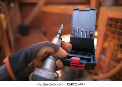 Safe Workplaces Male Construction Worker Hand Wearing A Safety Glove Holding Inspecting A Die Grinder Bit With Die Set Sizes Prior Used Drilling 