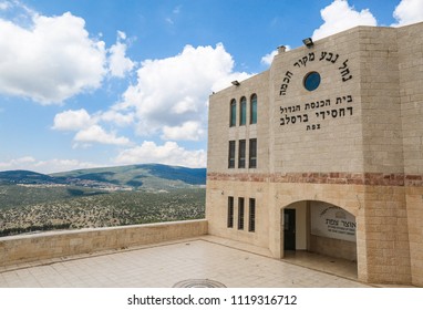 SAFED, ISRAEL - JUNE 3, 2018: The large, main Breslov synagogue in the Old Cty of Safed, Israel run by Rabbi Elazar Mordechai Kenig with a mountains of Galilee and cloudy sky background