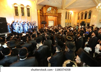 SAFED, ISRAEL  - OCT 8, 2017: Unidentified Jewish men and boys take part in a grand party in honor of the Jewish holiday of Sukkot in the Breslov Yeshiva School in Safed, Israel