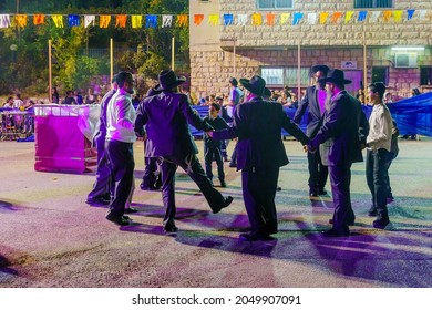 Safed, Israel - September 28, 2021: Jewish Men Dance, Part Of Simchat Torah Tradition, Women Are Behind The Barrier, In Safed (Tzfat), Israel