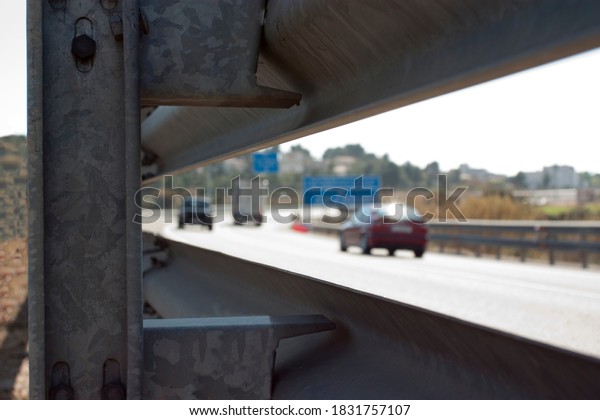 safety\
barrier on the road with vehicles\
circulating\
\
