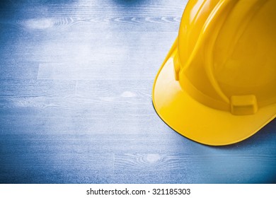 Safety building helmet on wooden board construction concept.