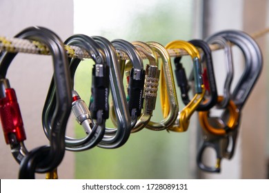 Safety carabiners of various manufacturers are suspended on a safety rope