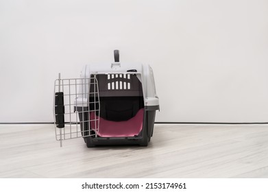 safety crate for dogs standing on the floor - Shutterstock ID 2153174961