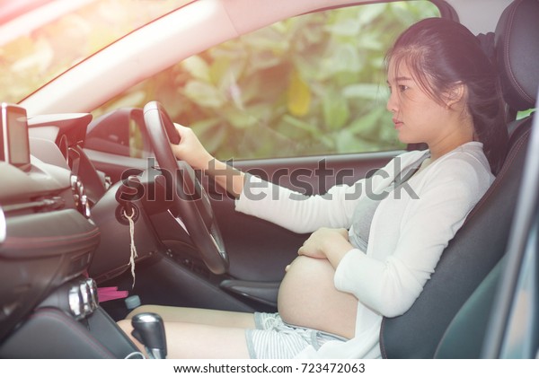 Safety driving for Pregnant women In Traffic her\
was thinking about the future of her baby, Safety driving concept\
and health care.