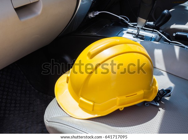 Safety\
Engineer Helmet  on the car seat\
background