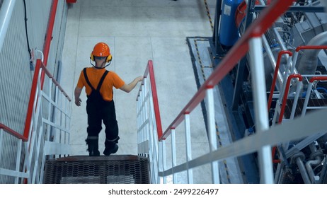 Safety engineer rushes accident site factory. Responding quickly emergency situation to ensure safety and mitigate damage. Wearing protective gear, prioritizing worker safety and emergency protocols. - Powered by Shutterstock