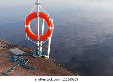 Safety Equipment. Bright Red Lifebuoy On The Pier