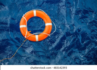 Safety equipment, Life buoy or rescue buoy floating on sea to rescue people from drowning man. - Shutterstock ID 483142393