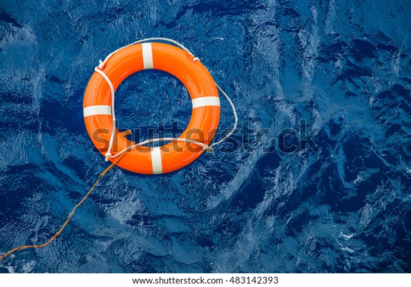 Safety equipment, Life buoy or\
rescue buoy floating on sea to rescue people from drowning\
man.