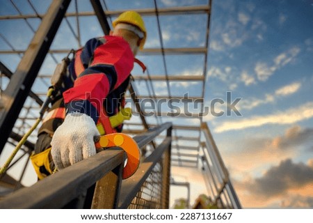 safety equipment Male construction worker working at height Wear safety clothes and safety harness for safety working in high place at construction site.