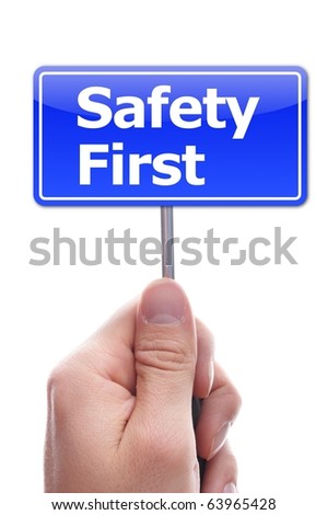 safety first concept with hand word and paper