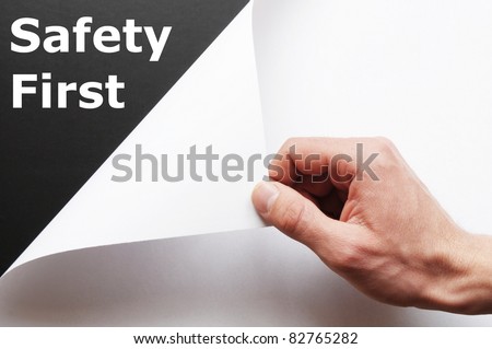 safety first concept with hand word and paper