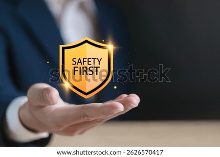 Safety first concept. Work safety, caution work hazards, danger surveillance and zero accident. Businessman showing safety first symbols on virtual screen.