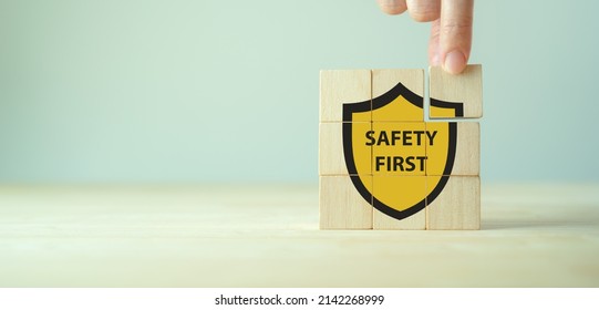 Safety first symbols, work safety, caution work hazards, danger surveillance, zero accident concept. Wooden cubes with smart grey background. Employees safety awareness at workplace. Safety banner.