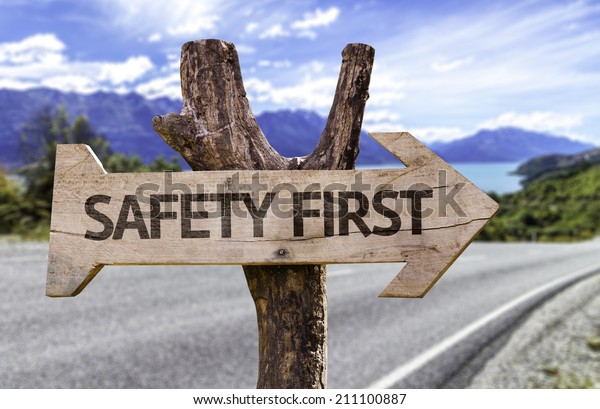 Safety First\
wooden sign with a street background\
