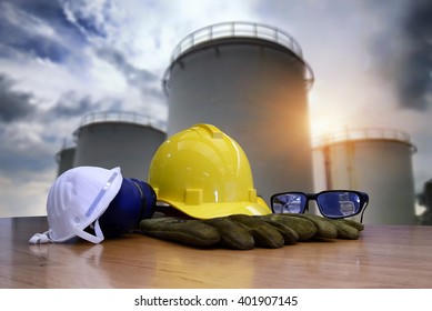 Safety Gear Kit Standing In Front Of Oil Refinery Background.