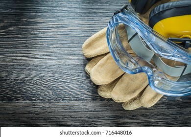 Safety Glasses Gloves Earmuffs On Wooden Board