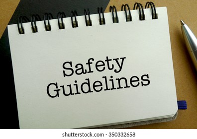 Safety Guidelines Memo Written On A Notebook With Pen