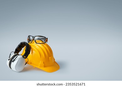 Safety helmet, ear muffs and goggles: personal protective equipment and workplace safety concept