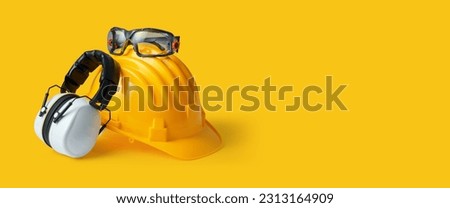 Safety helmet, ear muffs and goggles: personal protective equipment and workplace safety concept