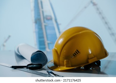 Safety helmet hat and projects of construction site building on a table. Building concept. Safety first. - Shutterstock ID 2171176425