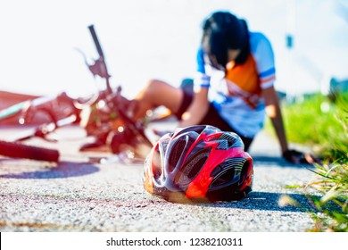 Safety Helmet Lost Off From Woman Bicyclist And Splatter Away From Head After Accident Clashed Impact On The Street Road, Injuried Hurt On Accident 