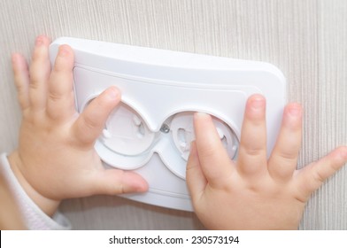 Safety Home For Children Concept - Electrical Safety Of Ac Power Outlet For Baby Hands