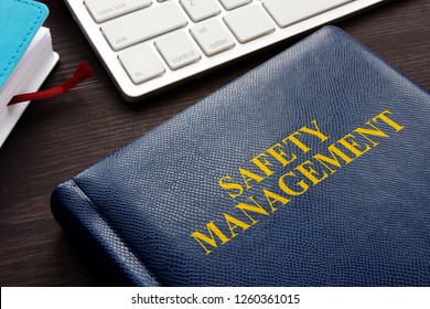 Safety Management Book And Keyboard On A Desk.